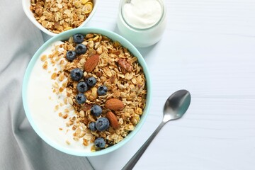 Delicious granola with berries and yogurt on the table