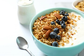 Delicious granola with berries and yogurt on the table