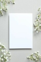 Top view photo with gypsophila flowers and paper card on gray background 