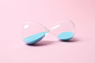 Modern hourglass on color background. Hourglass time concept for business deadline, urgency and...