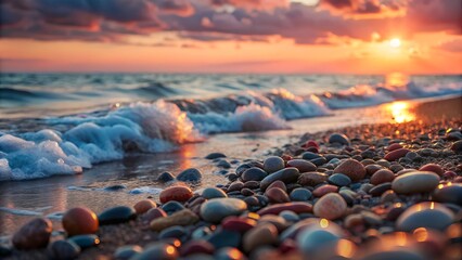 Scenic sunset over the ocean with colorful pebbles on the shore and gentle waves copy space
