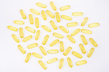 Omega 3 tablets isolated on white background . yellow pills close up. Fish oil capsules. Golden vitamin D3
