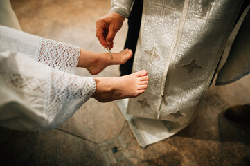 baptism ritual, priest anointed the girl's feet