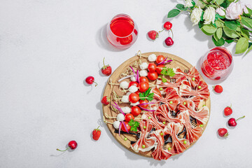Picnic food concept. Basket with wine and baguette, set of snacks on skewers. Meat, cheese