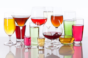 Variety of drinking glasses filled with colorful beverages