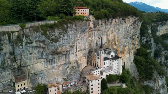 Panoramic aerial view of the Sanctuary of the Madonna della Corona, the church of Spiazzi, Caprino Veronese on the Monte Baldo massif, high above the Adige Valley, Italy