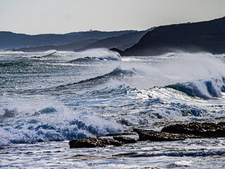 Wind Swept Waves Rush Past Dark Coast