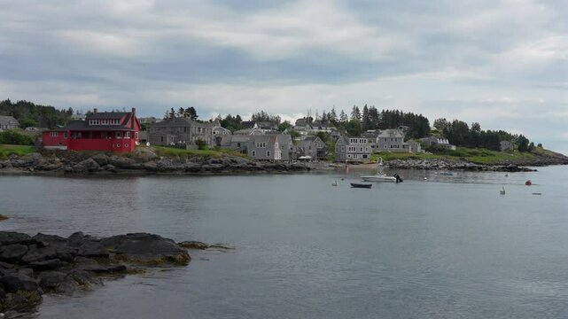 A panning view of the harbor at Monhegan Island of the northern coast of Maine on a cloudy day.