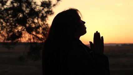 girl woman praying at sunset, hand sunset faith pain, asking heaven for help, spiritual sunset...