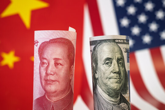Chinese currency yuan and U.S. dollars amerkinaische bills. concept of west versus east. The confrontation of superpowers. The Chinese economy versus the United States.