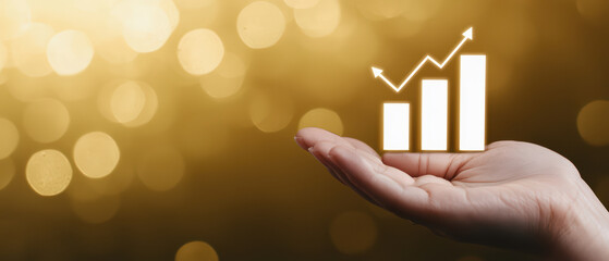 Hand supporting growth graph icon on golden bokeh background, symbolizing progress and success. image conveys optimism and potential