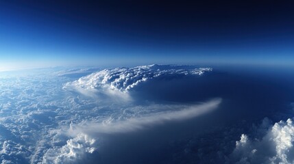 Aerial view of fluffy white clouds and blue sky.