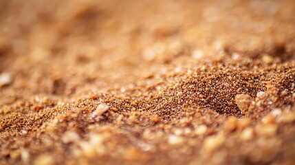 A close up of a pile of brown sand.