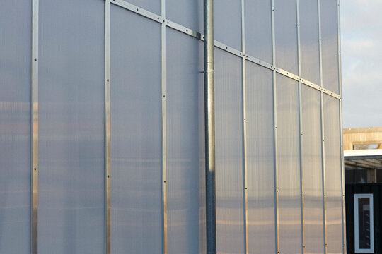 Modern frosted glass facade of an urban building at dusk with metal framework, Berlin, Germany
