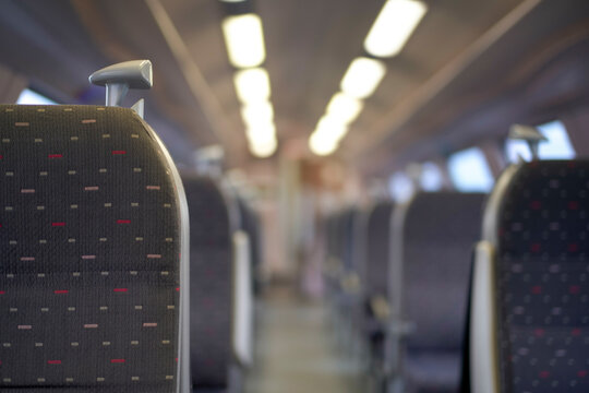 Empty train seats with a blurred background of the train interior