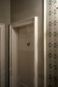 White door numbered 42, seen through a glass panel, Vienna, Austria