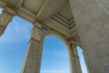 Fototapeta premium Tall, massive columns of a vintage, old building. Bottom-up view