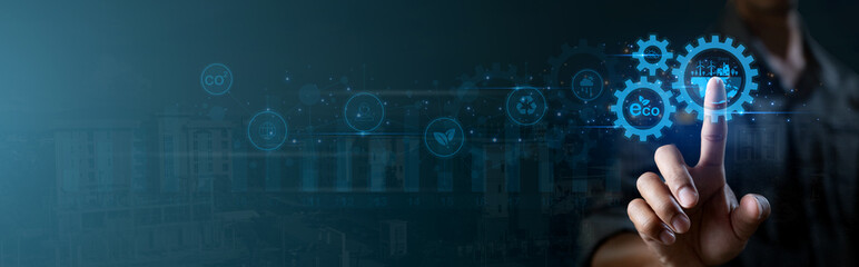 A blue screen with a person's hand pressing a button with renewable energy eco technology on virtual screen. Symbolizing innovation, Green Technology and Sustainability