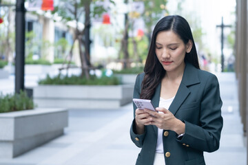 Asian businesswoman engaged on phone in urban lifestyle setting modern environment professional viewpoint