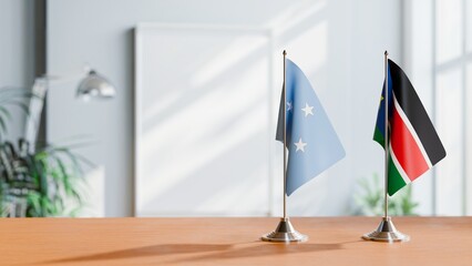 FLAGS OF MICRONESIA AND SOUTH SUDAN ON TABLE