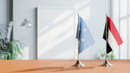 FLAGS OF MICRONESIA AND SUDAN ON TABLE