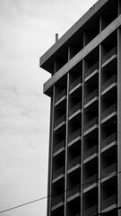 A black-and-white photograph of a building shot at 200mm compresses depth, drawing attention to the...