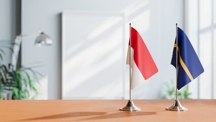 FLAGS OF MONACO AND NAURU ON TABLE