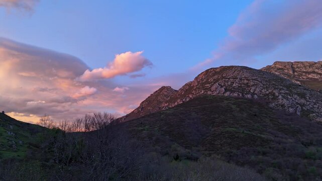 Drone flight over a spectacular landscape in the mountains of Quiros in Asturias, Spain with a sky of intense colors at sunset