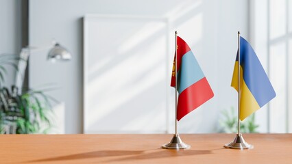 FLAGS OF MONGOLIA AND UKRAINE ON TABLE