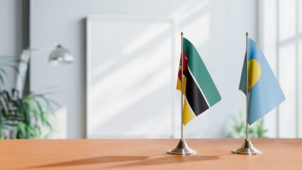 FLAGS OF MOZAMBIQUE AND PALAU ON TABLE