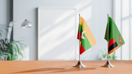 FLAGS OF MYANMAR AND ZAMBIA ON TABLE