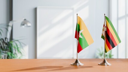 FLAGS OF MYANMAR AND ZIMBABWE ON TABLE