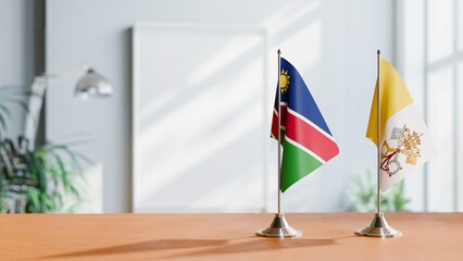 FLAGS OF NAMIBIA AND VATICAN ON TABLE