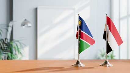 FLAGS OF NAMIBIA AND YEMEN ON TABLE