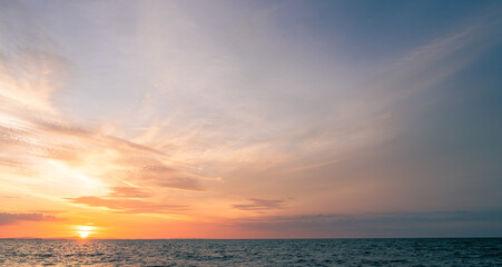Horizon sea sky background, Sunset sky clouds over sea in the evening with Orange, Yellow sunlight golden hour sun dawn landscape, Dusk sky seascape backgrounds