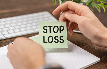 Businessman showing business card with stop loss text, concept.