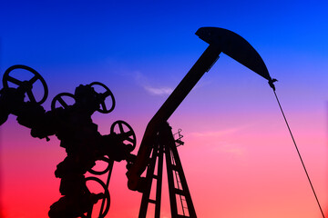 The pumping unit is working, in the silhouette of sunset
