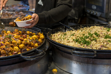 Street food. Grilled meat and side dish on a large pan for sale at the market