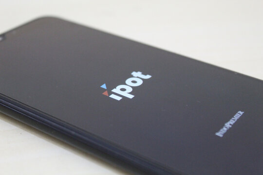 IPOT app logo display on a smartphone. IPOT app by Indo Premier Investment from Indonesia