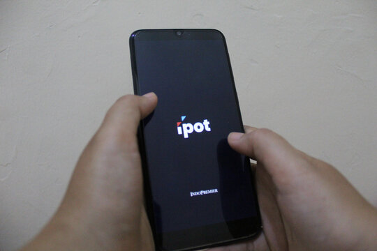 IPOT app logo display on a smartphone. IPOT app by Indo Premier Investment from Indonesia