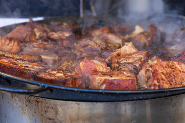 Street food. Grilled meat and side dish on a large pan for sale at the market