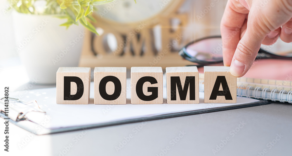 Poster dogma text on the wooden block with notebooks, keyboard with chart