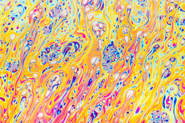 Real photograph of a colorful light interference on a soap bubble surface with random swirls,...