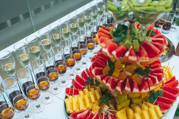 fruit and alcohol buffet in the restaurant. Sliced fruits arrangement. The dish in the restaurant. Lot of different fruits are on the catering table. 