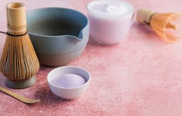 Traditional pink kit, Bamboo whisk and beverage on bamboo mat in the kitchen