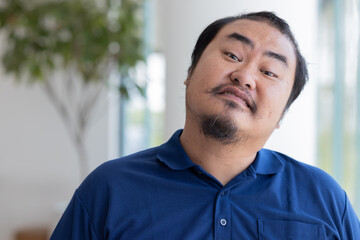 Obraz premium Angry Asian middle aged man with irritating expression, upset unhappy midage old real man staring at you with frustrated mood, upset emotion