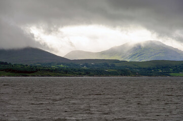 A cloudy day with a mountain in the background