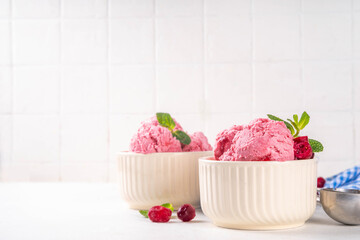 Homemade cranberry ice cream, creamy winter berry gelato with fresh cranberry and mint sprig in ceramic bowl