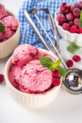 Homemade cranberry ice cream, creamy winter berry gelato with fresh cranberry and mint sprig in ceramic bowl