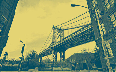 Manhattan Bridge between Manhattan and Brooklyn over East River seen from a narrow alley enclosed...
